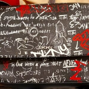 DKNY CROSSBODY PURSE BLACK WITH LOTS OF WRITING